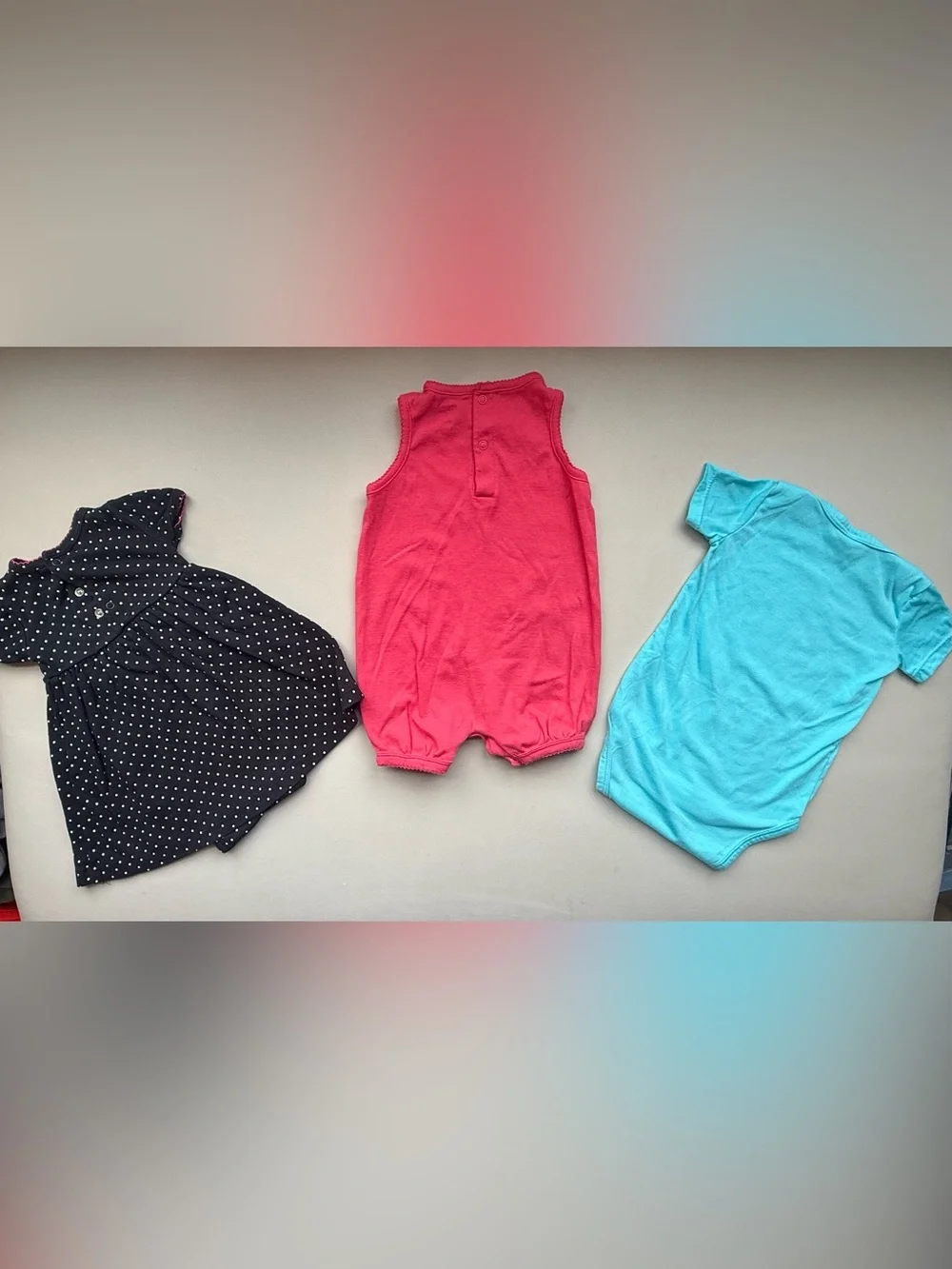 Bundle of 3 One-Piece Bodysuit - Coral, blue and black with white dots.